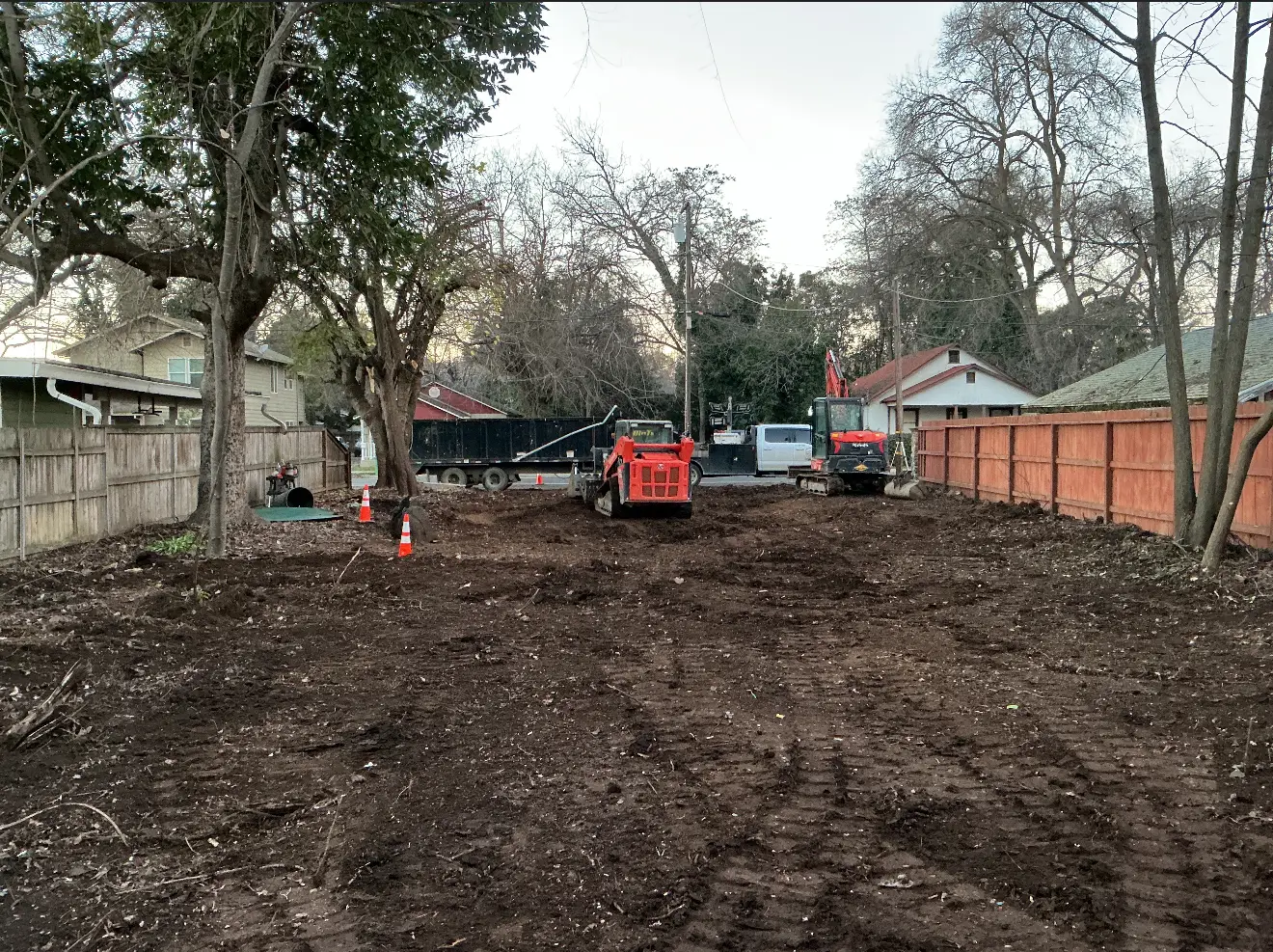 Demo Patrol skid steer and excavator on a cleared residential lot