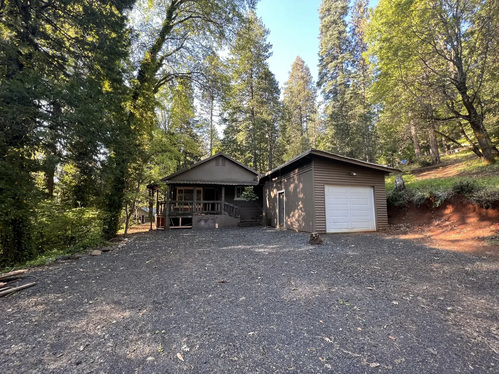Intact fire-affected home on wooded Magalia lot before demolition