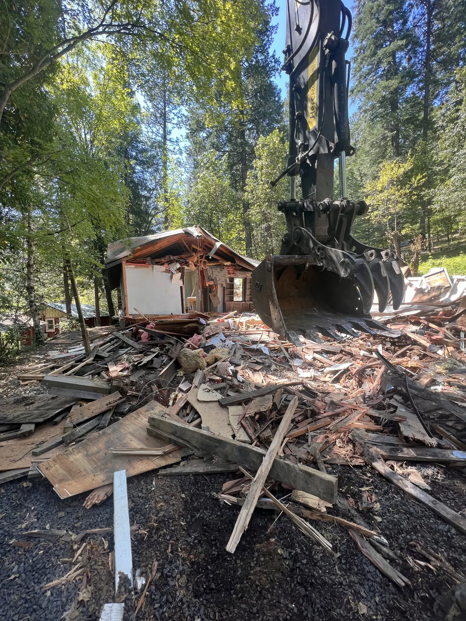 Demo Patrol crew demolishing a fire-damaged home in Magalia after the Camp Fire